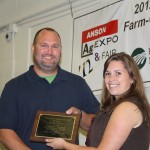 Producer Roddy Purser is awarded the 2012 Anson County Outstanding Farmer of the Year by Ag Agent Jessica Anderson.